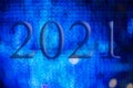 Text with the year number 2021 with a background of bright blue lights out of focus with Bokeh effect Royalty Free Stock Photo