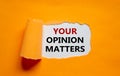 The text `Your opinion matters` appearing behind torn orange paper. Business concept. Copy space Royalty Free Stock Photo
