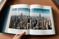 A textbook flipping open to a pop up cityscape