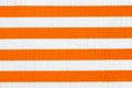 Textile background with orange and white stripes. Fabric texture