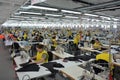 A textile company with a large number of workers behind its sewing machines Royalty Free Stock Photo