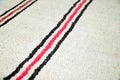 Textile cotton white rug with black and red stripes. Texture background. Close-up floor carpet Royalty Free Stock Photo