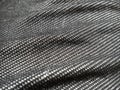 A textile fabric made on a loom by weaving mutually perpendicular thread systems. Black and white synthetic polyester fabric for