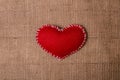 Textile heart on fabric texture of burlap Royalty Free Stock Photo