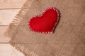 Textile heart on fabric texture of burlap Royalty Free Stock Photo