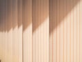 Textile lamellas of vertical blinds covering the window in the rays of sunlight Royalty Free Stock Photo