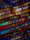 Textile pile colorful traditional andean indigenous handmade woven Otavalo handicraft market Ecuador South America