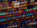 Textile pile colorful traditional andean indigenous handmade woven Otavalo handicraft market Ecuador South America