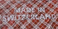 MADE IN SWITZERLAND text printed on a fabric, national textile production conceptual 3d rendering