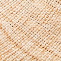 Texture of straw hat from interwoven raffia fibers