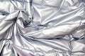 Textile and texture concept - close up of crumpled gray silver metallic fabric background Royalty Free Stock Photo