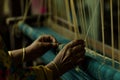 textile workers hands guiding thread on a loom Royalty Free Stock Photo