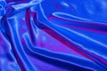 Textiles folds in neon blue-pink light. Trendy colors and shiny abstract background Royalty Free Stock Photo