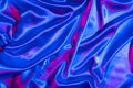 Textiles folds in neon blue-pink light. Trendy colors and shiny background Royalty Free Stock Photo