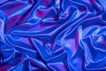 Textiles folds in neon blue-pink light. Trendy colors and shiny abstract background Royalty Free Stock Photo