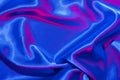 Textiles folds in neon blue-pink light. Trendy colors and shiny abstract background Royalty Free Stock Photo