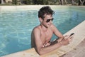 Texting a Message on the Pool Royalty Free Stock Photo