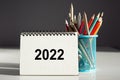 2022 texton the notepad and blue pencil holder on gray background