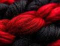 Textural abstraction: vivid red intertwined with profound black yarn strands Royalty Free Stock Photo