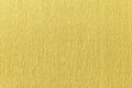 Textural of golden background of wavy corrugated paper, closeup