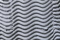 Textural monophonic background of plaster plaster gray, with a pattern in the form of waves