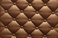 Textural rhomb ornament on brown upholstery. Close up