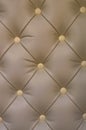 Textural rhomb ornament on brown upholstery. Close up