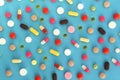 Texture from different medicines, tablets and capsules on a blue background. Royalty Free Stock Photo