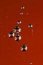 Texture of air bubbles group in water on red backroud