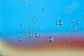 Texture of air bubbles in water on blue, yellow and red backr Royalty Free Stock Photo