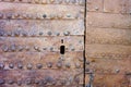 Texture of an ancient rusty iron door with rivets and keyhole Royalty Free Stock Photo