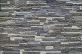 Texture - artificial decorative stone faÃÂ§ade. Decorative grey color rough stone wall background texture. Royalty Free Stock Photo