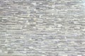 Texture - artificial decorative stone faÃÂ§ade. Decorative grey color rough stone wall background texture. Royalty Free Stock Photo