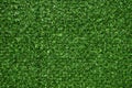 Texture of artificial green grass fencing panel as background Royalty Free Stock Photo