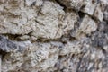 Texture background. Antique flagstone natural stone wall with selective shallow focus at the beginning and blurred distal part Royalty Free Stock Photo