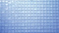 Texture background blue mosaic, small square transparent tiles on the wall.Glass Panel For Kitchens Royalty Free Stock Photo