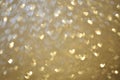 Texture background with bokeh hearts of gold color