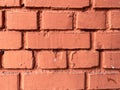 Texture, background. bricks are laid in one row and covered with a layer of red paint. volumetric 3d texture. concrete mix bricks