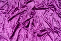 Texture, background of folded purple satin fabric