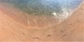 Footprints of human feet on the sand near the water on the beach