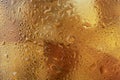 Texture background of a glass of Golden whiskey or Scotch close - up-drops and misted glass, blurred ice Royalty Free Stock Photo