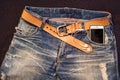 Texture background of jeans , belt detail with mobilephone and e