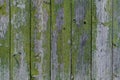 Wooden background: old fence with peeling green paint Royalty Free Stock Photo