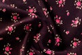 Texture, background, pattern. Fabric dark cherry color With small flowers roses, Antique Rose - Half Yard - Tan with Small Scale Royalty Free Stock Photo