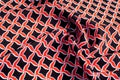 Texture, background, pattern. Fabric drawing of a diamond diamond red on a black background Royalty Free Stock Photo
