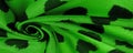 Texture, background, pattern, postcard, silk fabric, green print from the fabric of black hearts, your projects will not go Royalty Free Stock Photo