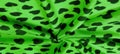 Texture, background, pattern, postcard, silk fabric, green print from the fabric of black hearts, your projects will not go Royalty Free Stock Photo