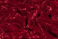 Texture, background, pattern, red fabric with paillettes. Look Royalty Free Stock Photo