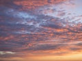 Texture, background, pattern. Sunset or dawn colored tropical clouds, red, pink, blue, orange and yellow pastel colors Royalty Free Stock Photo