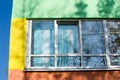 Texture, background, pattern. The wall of the building is painted with bright colors, a game of shadows from trees Royalty Free Stock Photo